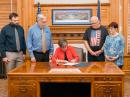 Amateur Radio Field Day Proclamation, signed by Kansas Governor Laura Kelly. Looking on, from left to right, are Assistant Section Manager of the ARRL Kansas Section Kenneth A. Kopp, AKØA; Joseph Pajor, KBØKFH; Charles Tucker, KBØSQL, and Terryl Pajor.